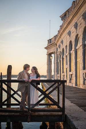 Couple laughing by historic building