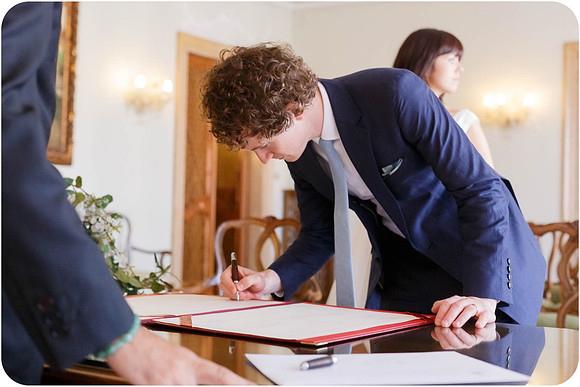 Bride in a joyful moment after signing the marriage certificate.