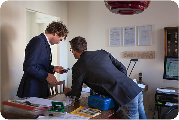 Groom in a navy suit preparing for his wedding in Venice.