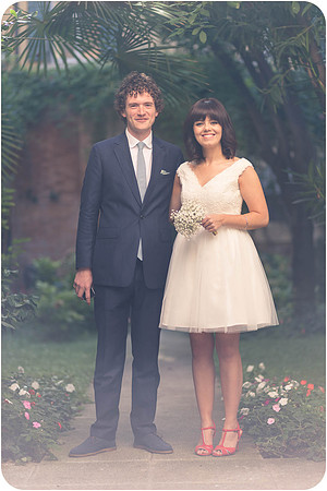 Bride and groom standing together in a Venice garden.