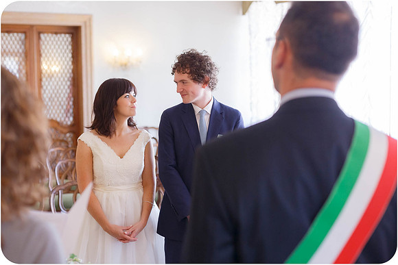 Bride and groom standing with the officiant before exchanging vows.