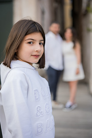 Daughter standing by a canal during a family vacation in Venice