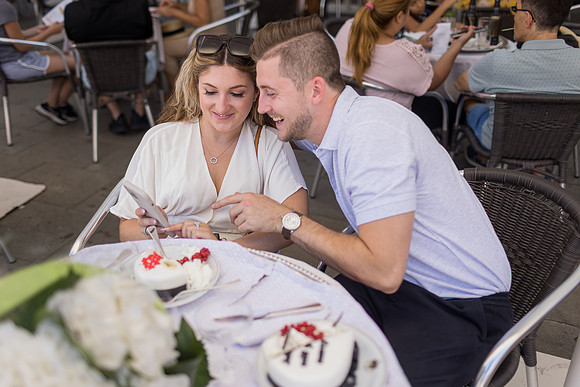 Engaged couple embracing at Café Florian