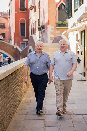 Grandfather and grandson walking in Venice