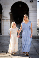 Mother and daughter under Venetian arches