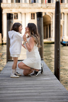 Daughter posing on a bridge with scenic Venice in the background
