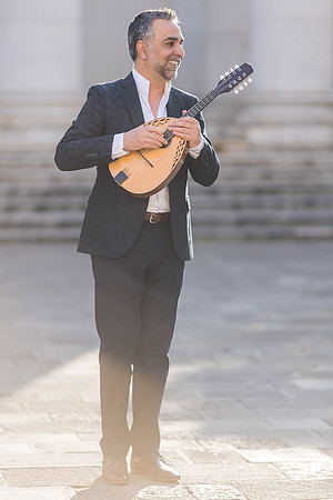 Profile view of a mandolin player in Venice