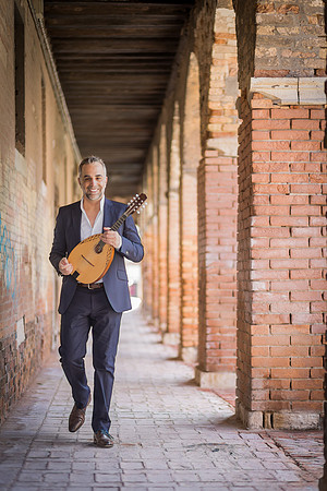 Musician walking in a narrow street in Venice
