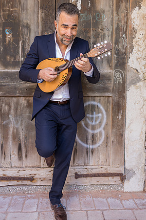 Musician walking with a mandolin in Venice
