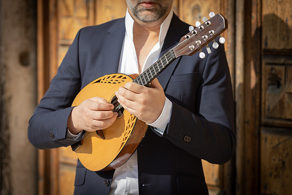 Close up of a man playing mandolin