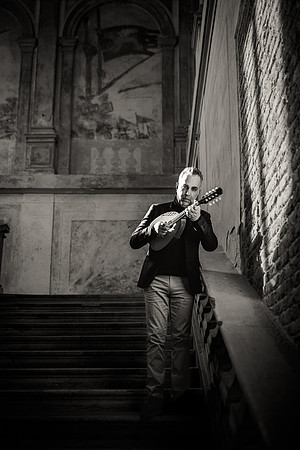B&W photo of a musician in a street