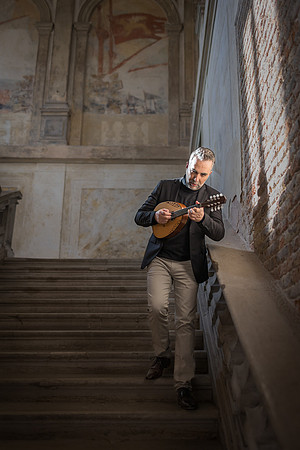Musician posing in front of classical architecture