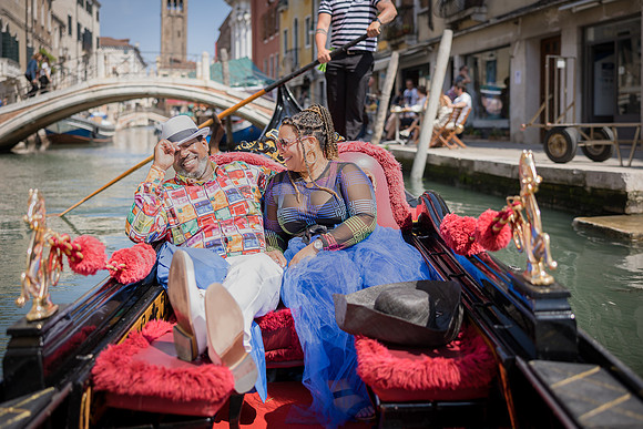 Couple relaxing on a gondola while exploring Venice’s charming canals.