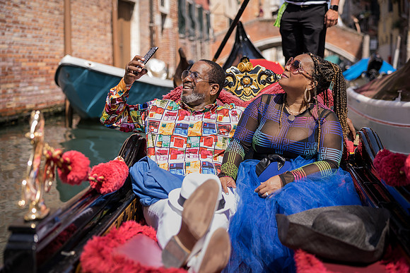 Couple laughing together on a gondola ride in Venice.