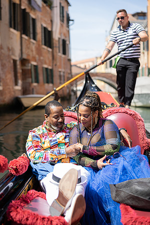Couple in love enjoying a cozy gondola ride in Venice.