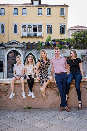 Family enjoying time near a Venetian canal during a family vacation photo session