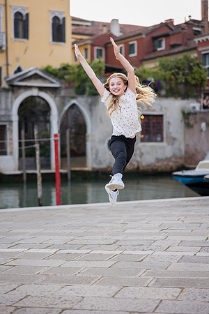 Children having fun in a peaceful Venetian neighborhood during their family vacation