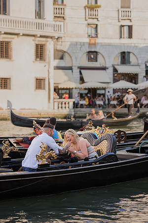 A tearful yes and a loving embrace during a magical gondola proposal.