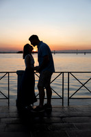 Silhouette of a couple embracing at twilight in Venice.