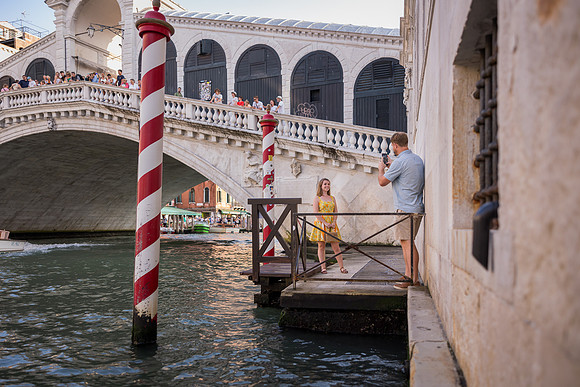 Couple standing near the water at the Rialto Bridge