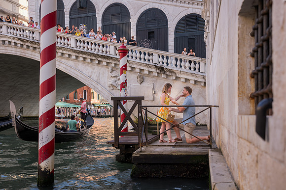 Couple kissing after engagement near the Rialto Bridge