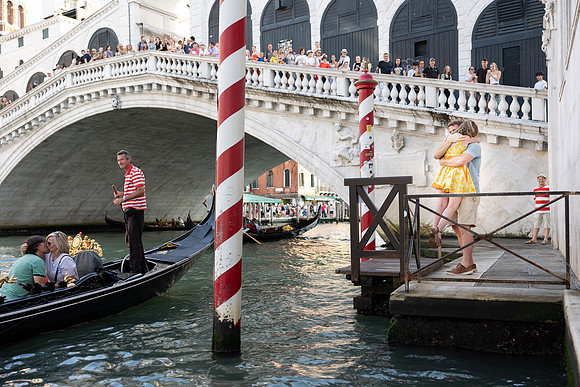Couple celebrating their engagement with gondolas in Venice