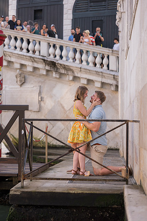Couple kissing after engagement near Rialto Bridge