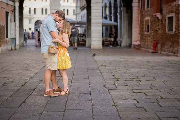 Couple embracing near Rialto Bridge after proposal