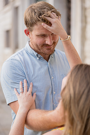 Man touching his fiancée’s face in an emotional moment