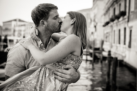 Couple kissing passionately near the Rialto Bridge