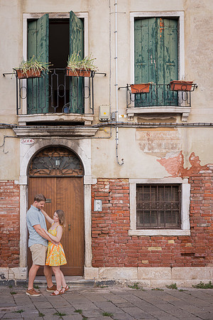 Couple posing near an old Venetian building after engagement