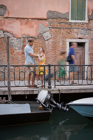 Couple walking on a bridge in Venice after engagement