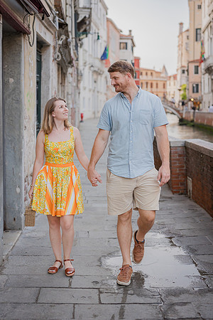 Engaged couple standing together in a quiet Venice alley