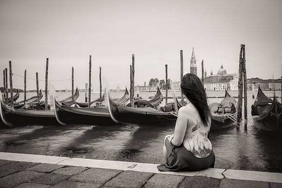 Woman reflecting with her dog in Venice.