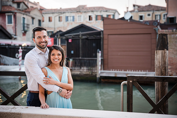Engaged couple kissing at sunset in Venice