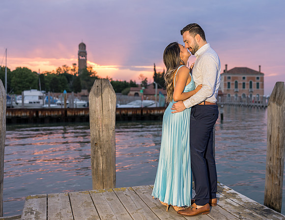 Engaged couple hugging at sunset in Venice
