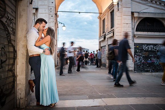 Engaged couple laughing in the streets of Venice