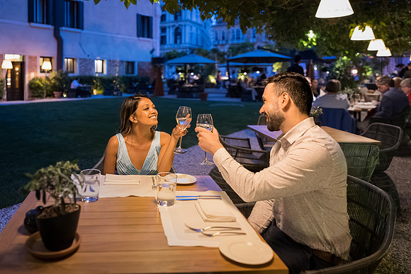 Engaged couple toasting under the stars in Venice