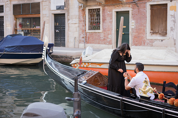 Gondola riding through a narrow Venetian canal