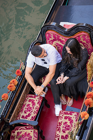 Couple smiling on a gondola after proposal