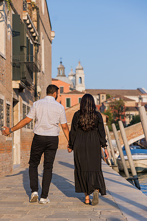 Happy couple walking through Venice