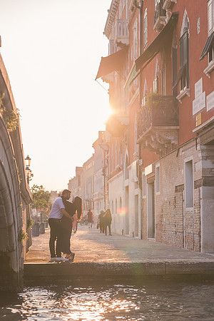 Couple walking away from camera in Venice