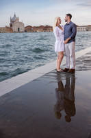 Couple walking in Venice at twilight after their engagement.