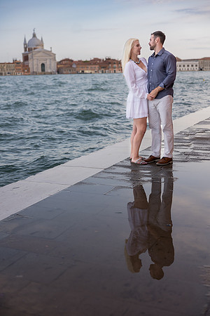 Couple walking in Venice at twilight after their engagement.