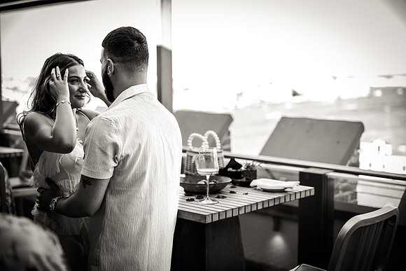 Engaged couple sharing a warm hug on a Venetian rooftop.
