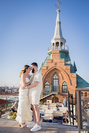 Couple standing on a rooftop in Venice with a stunning skyline.