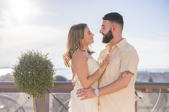 Engaged couple embracing on a rooftop terrace in Venice.