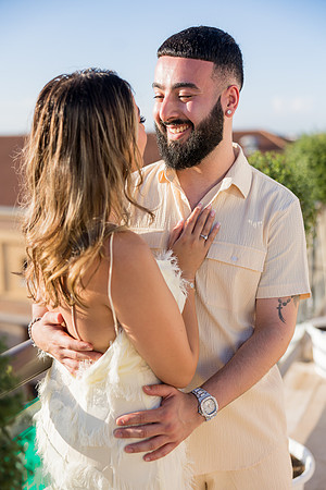 Couple embracing with soft sunlight highlighting their love.