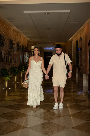 Couple walking in an elegant Venetian corridor after their engagement.