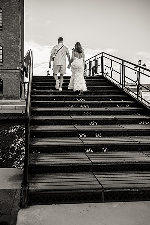Engaged couple walking up a bridge in Venice, hand in hand.